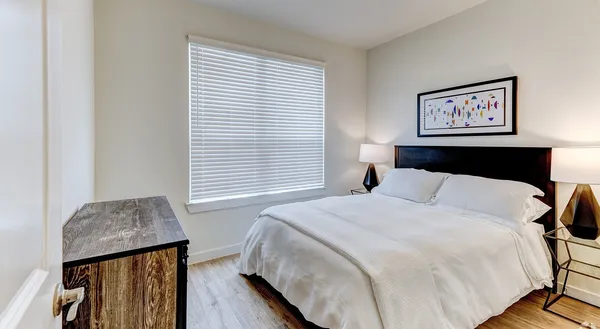 a bedroom with bed and a window