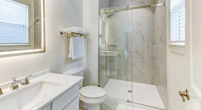 a bathroom with a sink toilet and shower