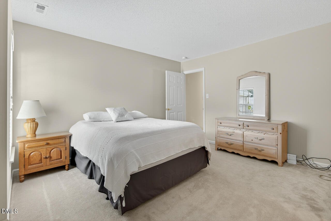 408 Intern Way Durham, NC 27713 - Photo 16 of 27 a bedroom with a bed and dresser