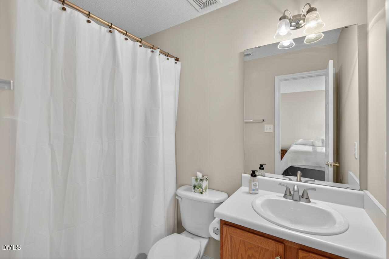 408 Intern Way Durham, NC 27713 - Photo 17 of 27 a bathroom with a sink and a mirror