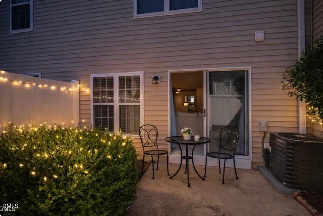 a view of yellow house with a large window and yard