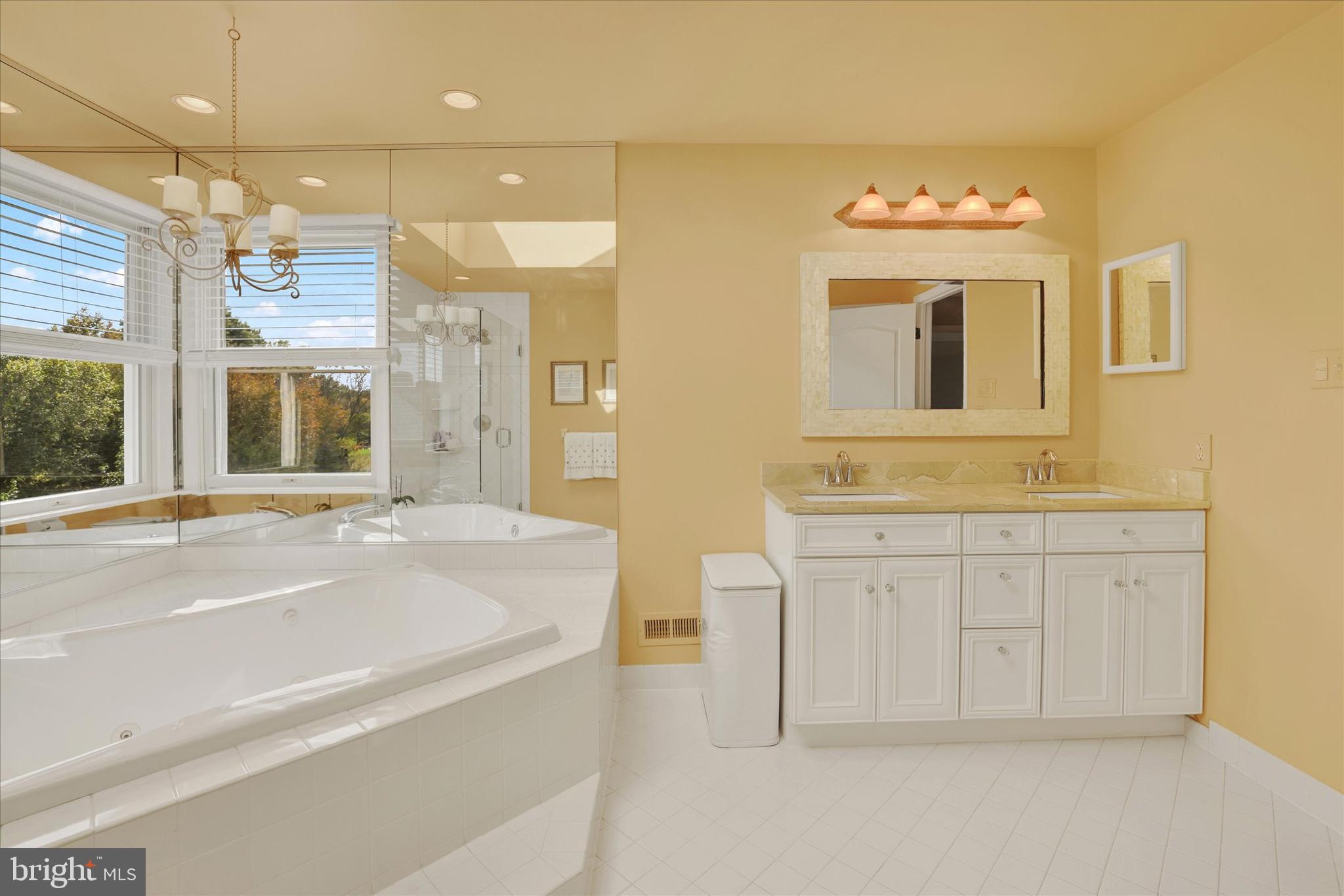 4925 Redfield Road Doylestown, PA 18902 - Photo 39 of 53 a spacious bathroom with a granite countertop sink a mirror and a bathtub