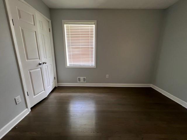 6935 Fielder Road Rex, GA 30273 - Photo 16 of 22 an empty room with wooden floor and windows with curtains