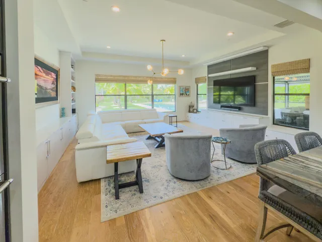 a living room with furniture a ceiling fan and a window