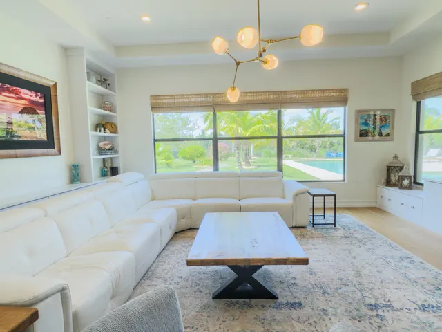 a bedroom with furniture and a large window