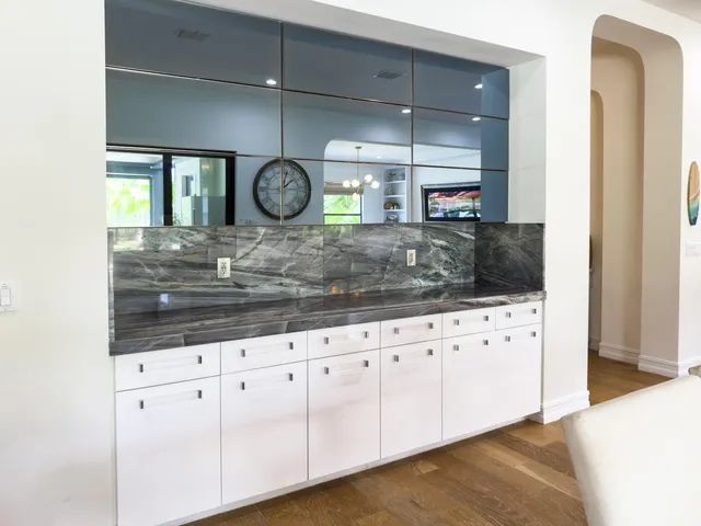 a bedroom with bed and a flat tv screen on dresser