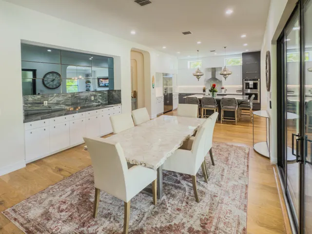 a spacious bedroom with a bed and a chair