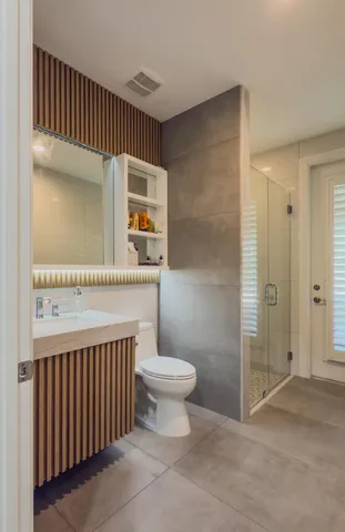 a view of a swimming pool with a lounge chair and palm trees