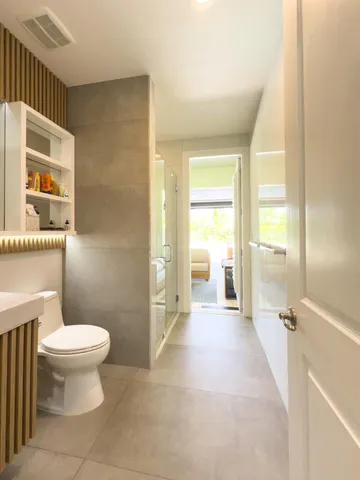 a view of a house with pool and chairs