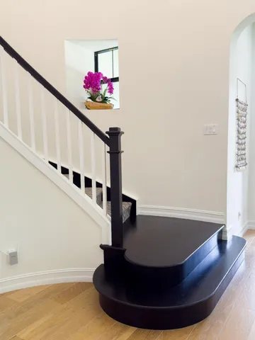 a view of a dining room with furniture a chandelier and wooden floor