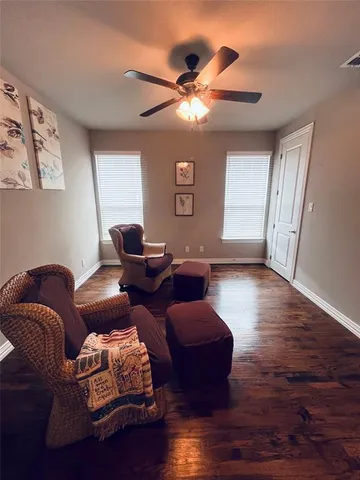 a living room with furniture and wooden floor