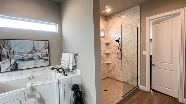 a bathroom with a shower tub and mirror