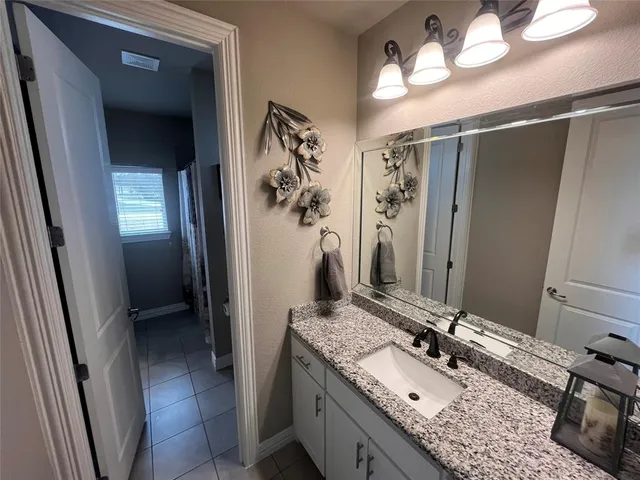 a bathroom with a double vanity sink and a mirror