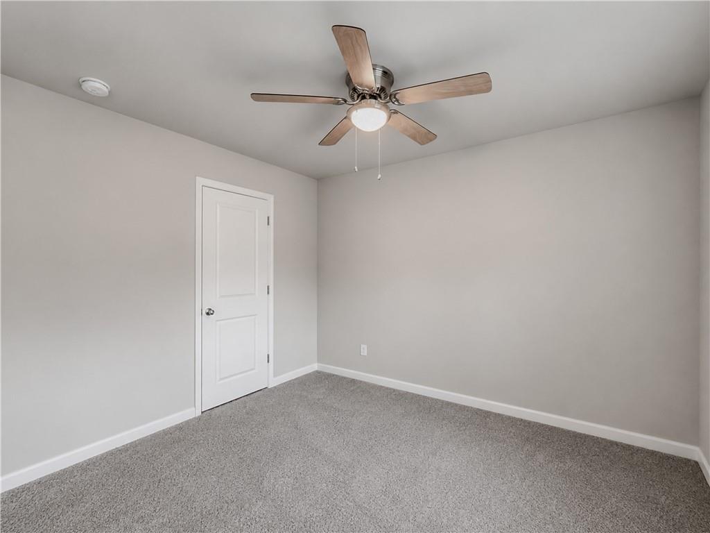 206 Morning Drive Athens, GA 30606 - Photo 23 of 36 an empty room with a ceiling fan and wooden floor