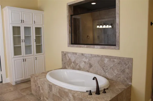 a bathroom with a tub and shower