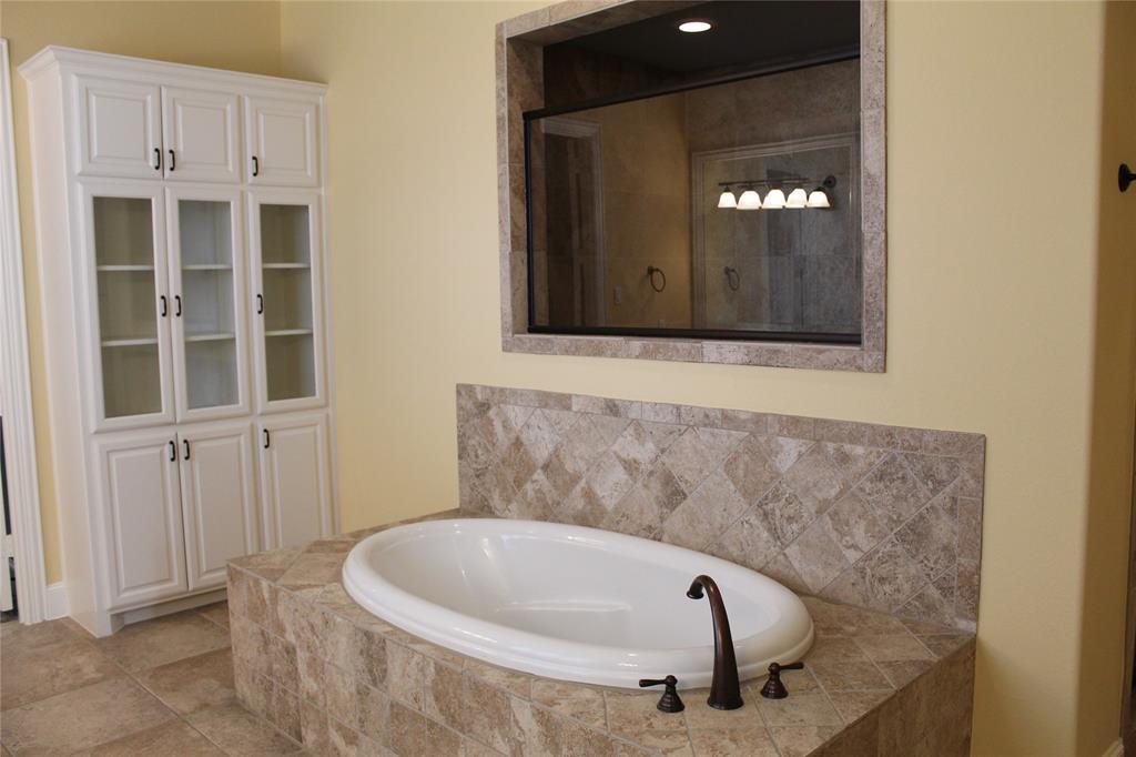 1835 Olney Drive Allen, TX 75013 - Photo 15 of 29 a bathroom with a tub and shower