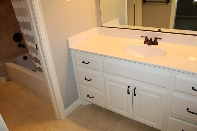 a bathroom with a bathtub and shower