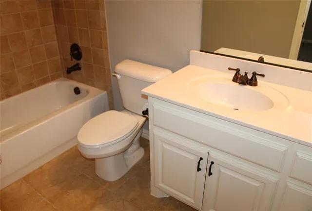 a white toilet sitting next to a bathroom sink
