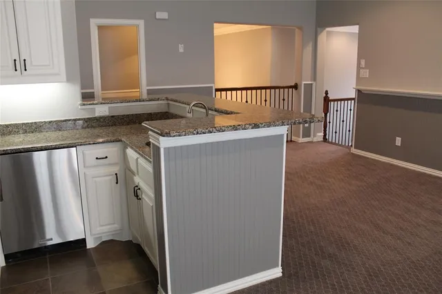 a kitchen with a refrigerator and window