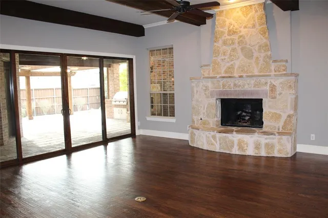 a living room with a fireplace and a floor to ceiling window
