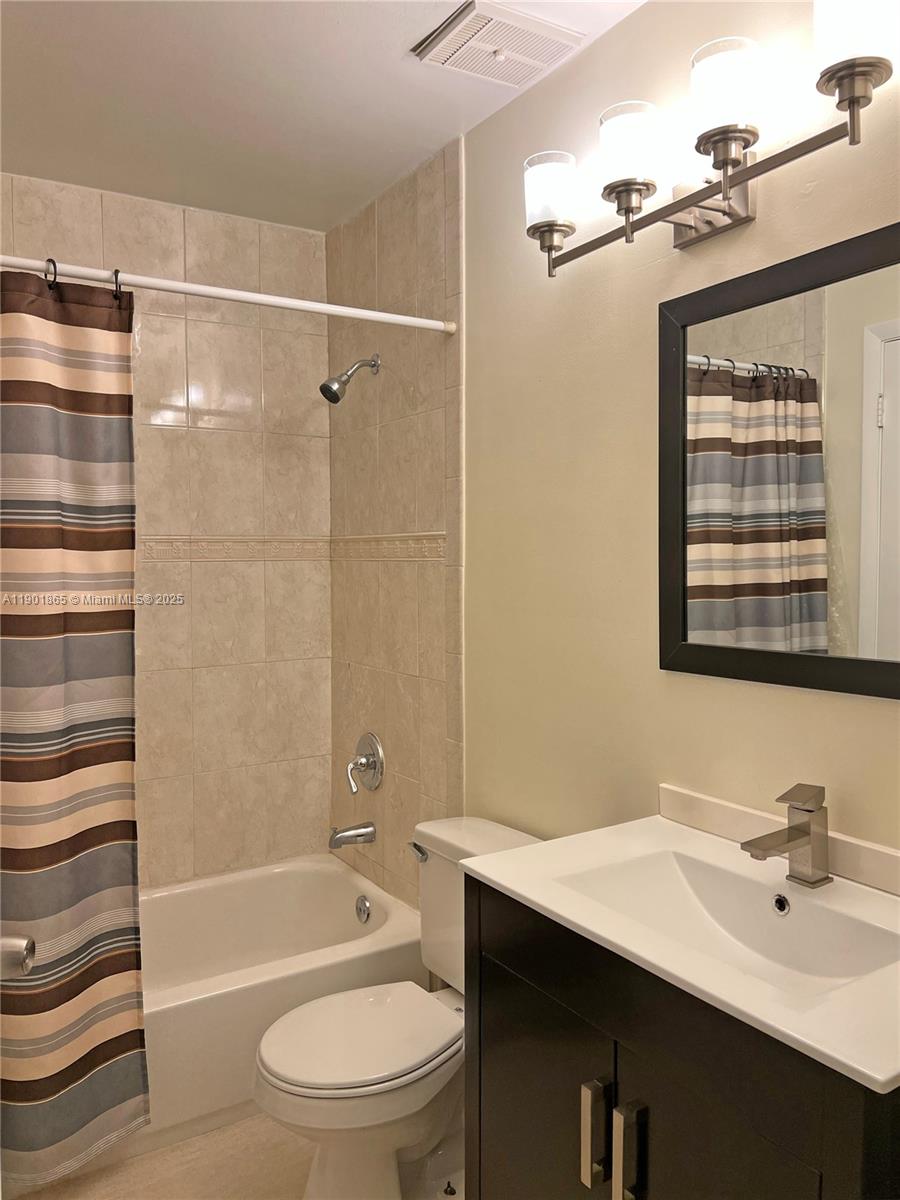 14015 Southwest 91st Terrace, Unit 14015 Miami, FL 33186 - Photo 12 of 20 a bathroom with a sink a toilet and shower