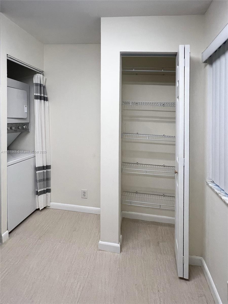 14015 Southwest 91st Terrace, Unit 14015 Miami, FL 33186 - Photo 13 of 20 a view of walk in closet with empty racks