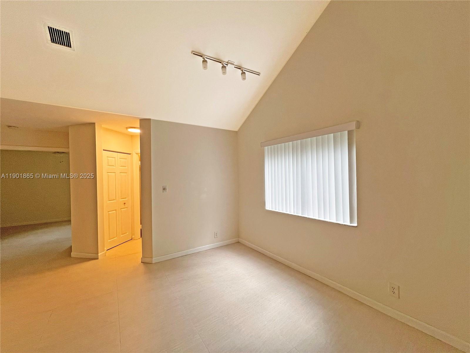 14015 Southwest 91st Terrace, Unit 14015 Miami, FL 33186 - Photo 14 of 20 a view of an empty room with a window