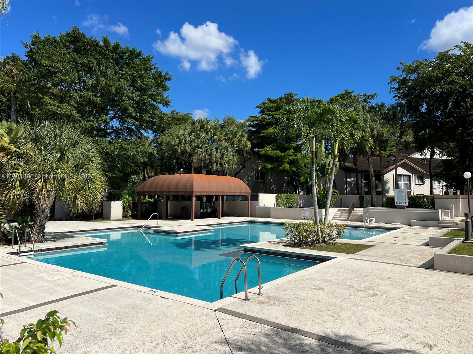 14015 Southwest 91st Terrace, Unit 14015 Miami, FL 33186 - Photo 16 of 20 a view of a swimming pool with a patio