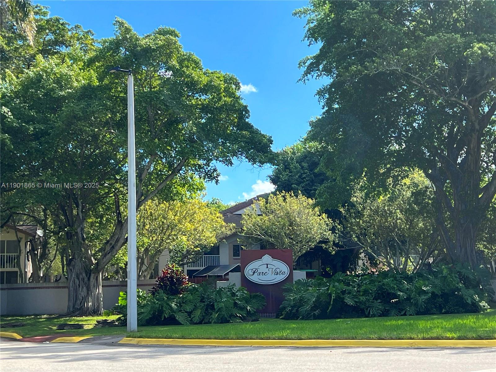 14015 Southwest 91st Terrace, Unit 14015 Miami, FL 33186 - Photo 20 of 20 a view of a yard with plants and large trees