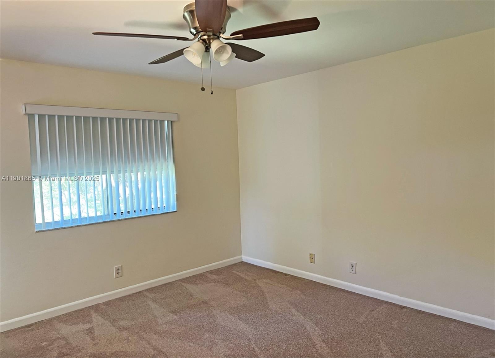 14015 Southwest 91st Terrace, Unit 14015 Miami, FL 33186 - Photo 7 of 20 an empty room with a window and a fan
