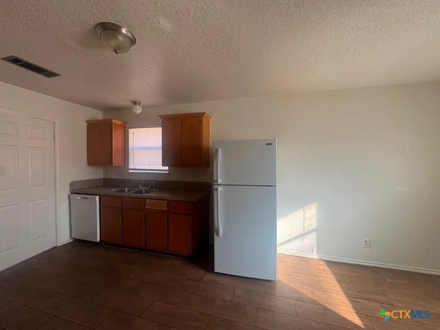 a kitchen with stainless steel appliances granite countertop a stove and a sink