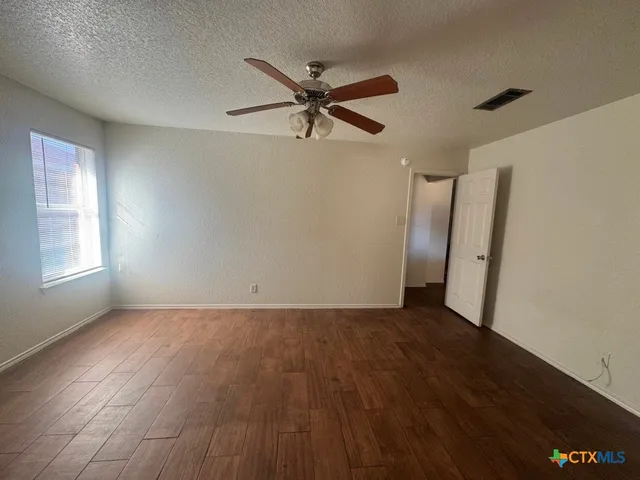 a bathroom with a granite countertop sink a toilet and a bathtub
