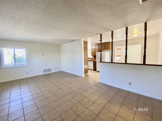401 South Fountain Street Ridgecrest, CA 93555 - Photo 6 of 29 a view of a livingroom with an empty space and a large window