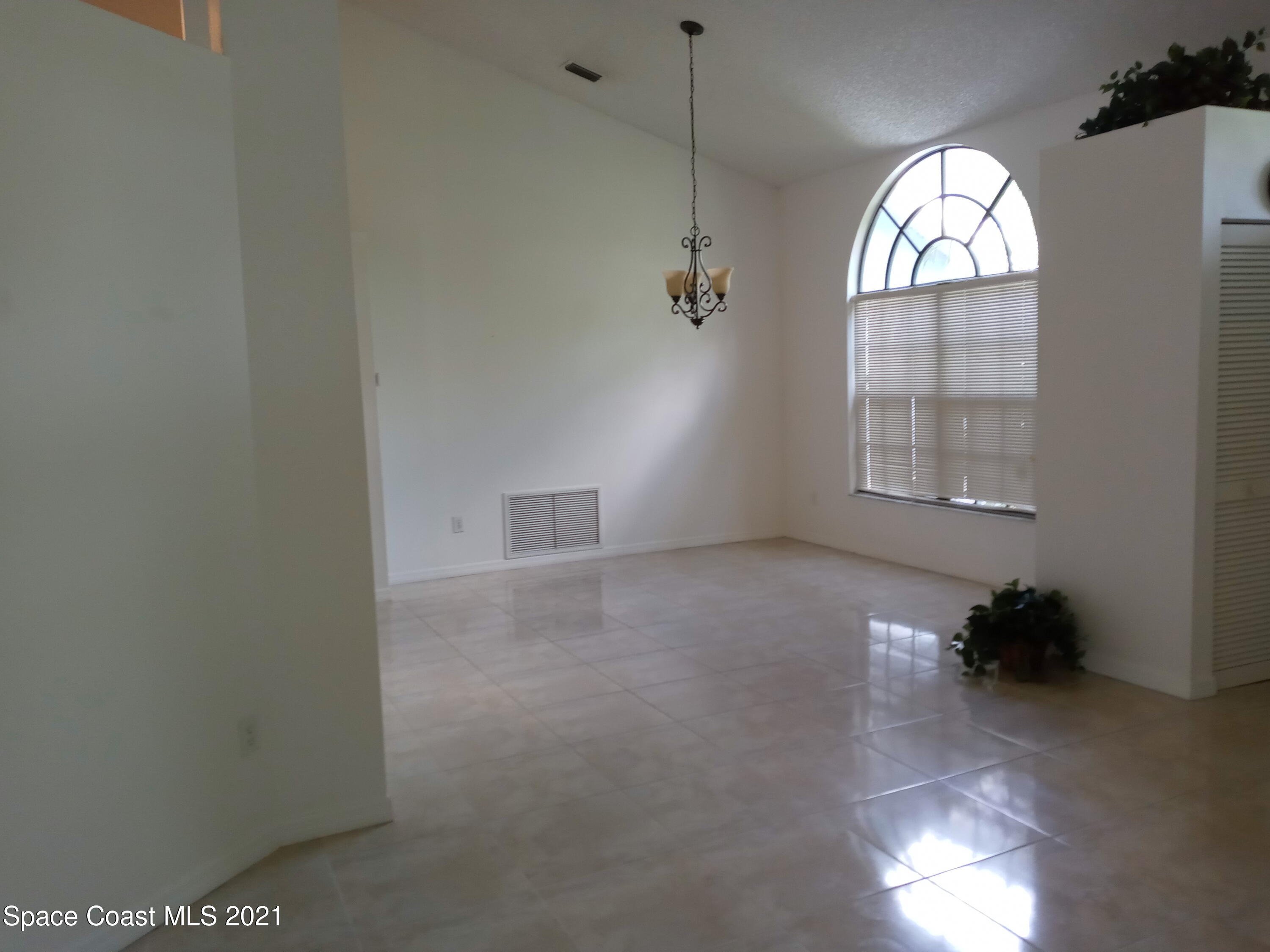 798 Riviera Drive Northeast Palm Bay, FL 32905 - Photo 6 of 7 a view of an empty room with a window