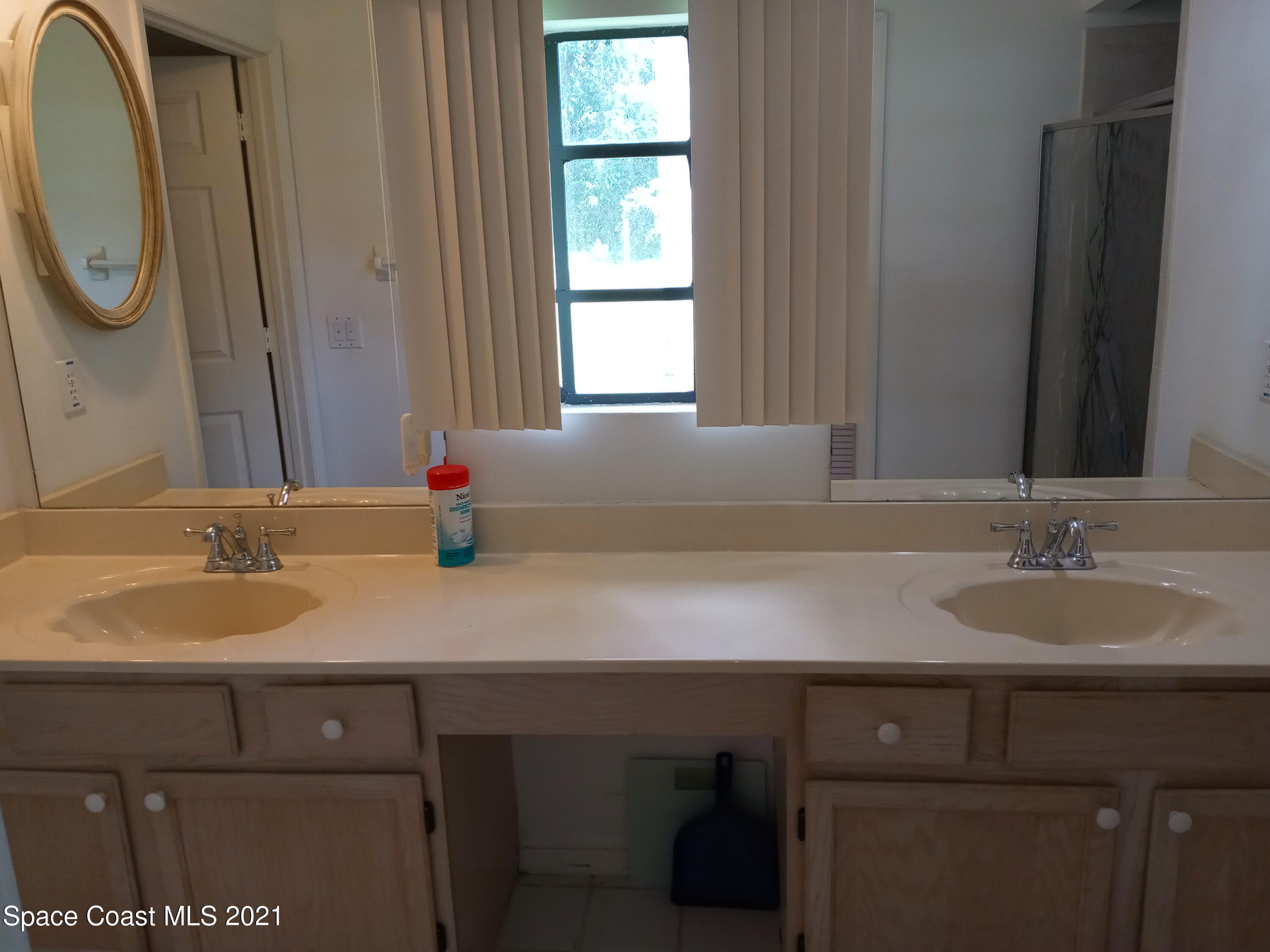 798 Riviera Drive Northeast Palm Bay, FL 32905 - Photo 7 of 7 a bathroom with a granite countertop sink a mirror and a window