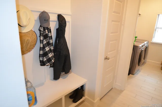a view of a hallway with wooden floor and a window