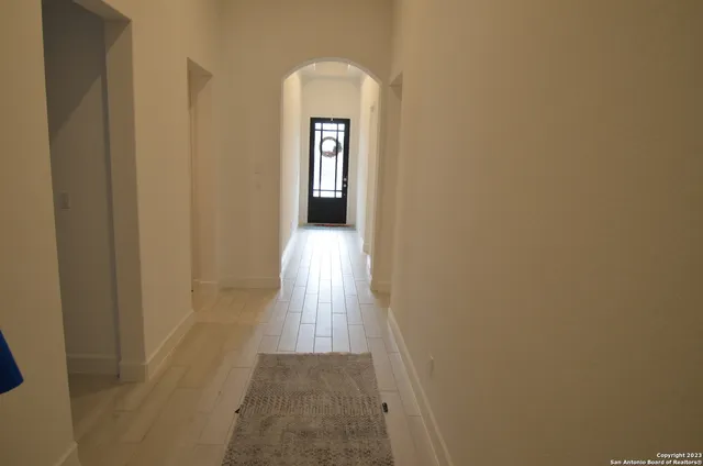 a view of a big yard with an tree and fence