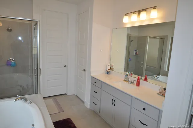 a bathroom with a bathtub and a shower