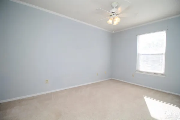 an empty room with a chandelier fan and closet area