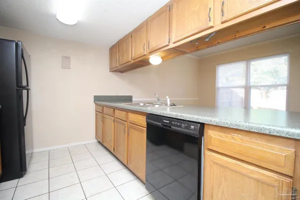 a kitchen with stainless steel appliances granite countertop a sink and a cabinets