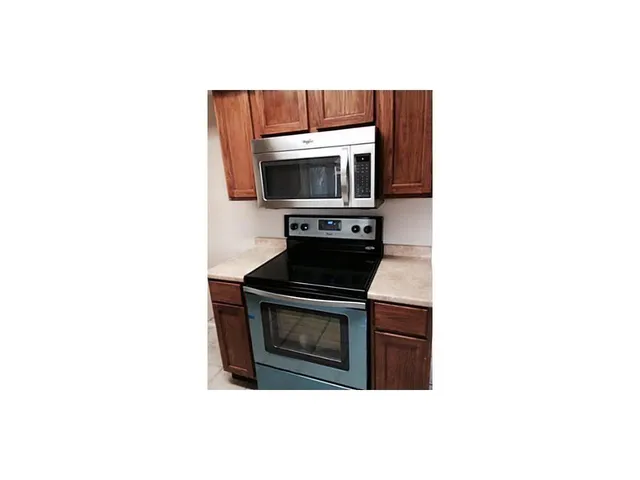 a kitchen with a stove and a microwave