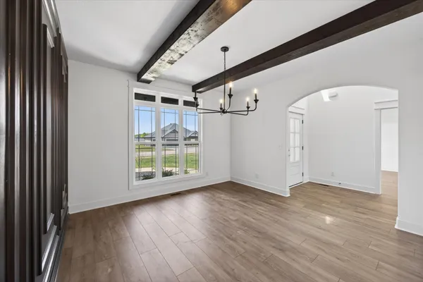 a view of an entryway with wooden floor
