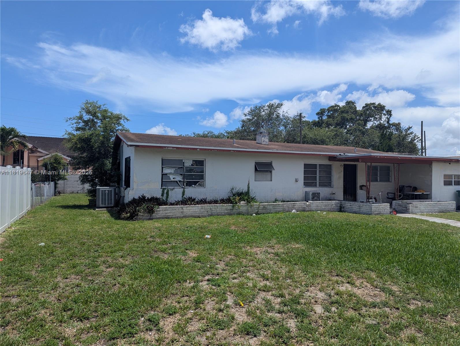 950 Northeast 172nd Street Miami, FL 33162 - Photo 2 of 3 a view of a house with backyard sitting area and garden