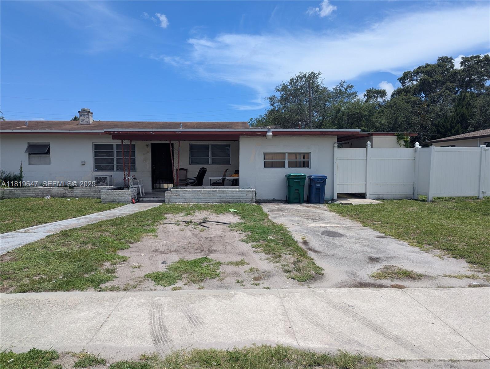 950 Northeast 172nd Street Miami, FL 33162 - Photo 3 of 3 a front view of house with yard and green space