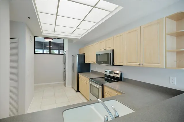a kitchen with stainless steel appliances a refrigerator and a stove top oven