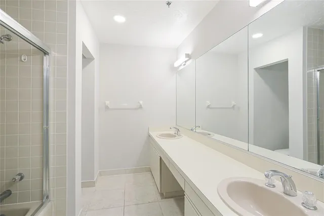 a bathroom with a tub sink and mirror