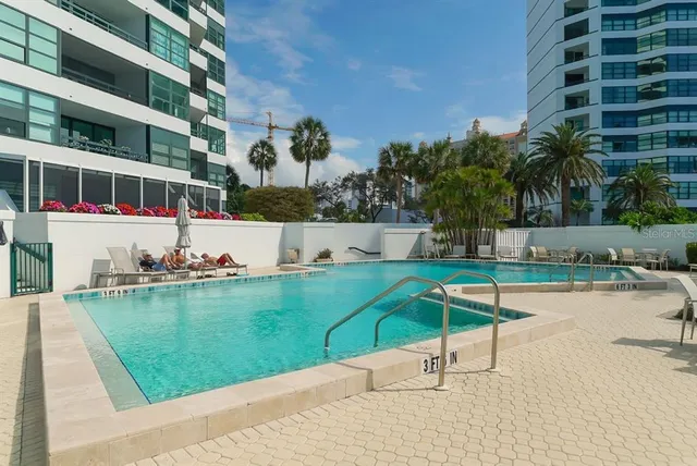 a view of a swimming pool with a table and chairs