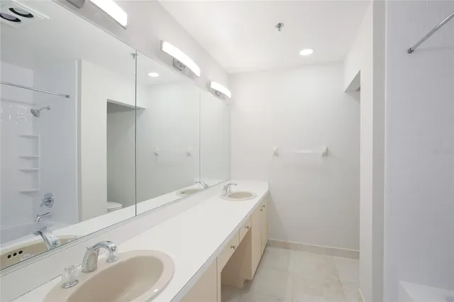 a bathroom with a double vanity sink and a mirror