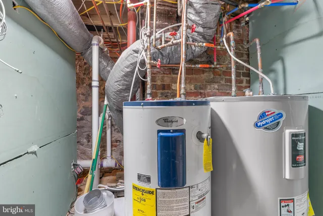 a bed room with a bed and a refrigerator