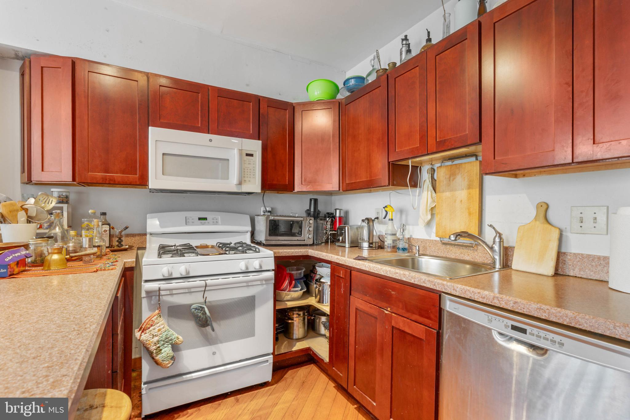 105 South 2nd Street Philadelphia, PA 19106 - Photo 32 of 54 a kitchen with a stove top oven sink and cabinets